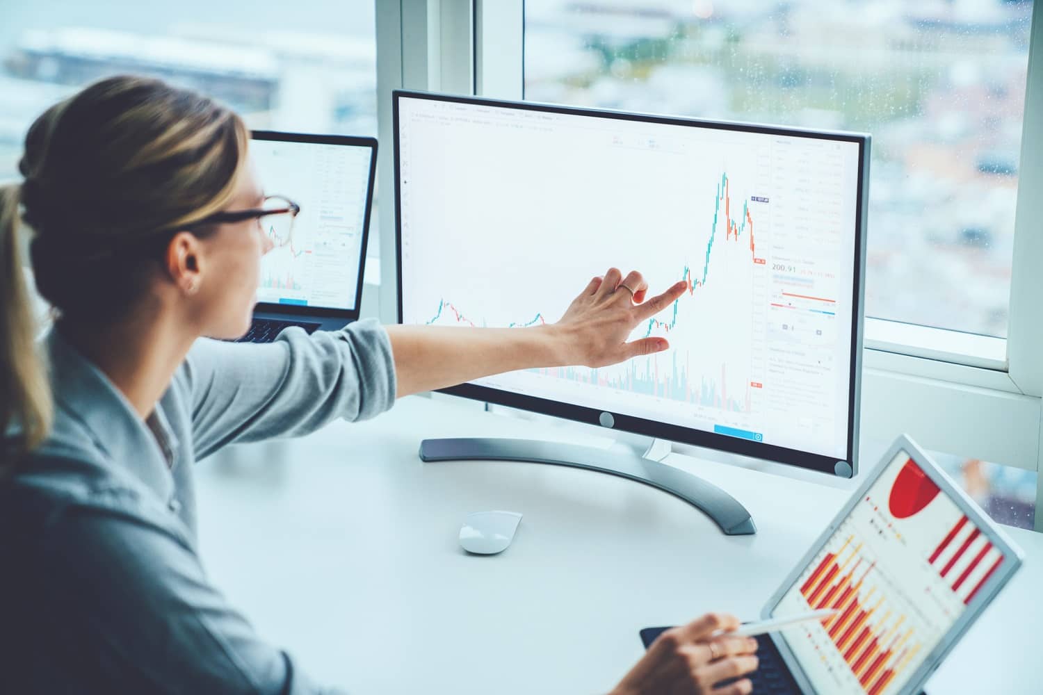 Businesswoman looking at a line chart on a computer screen