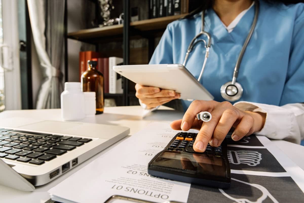 Doctor entering billing information into a computer