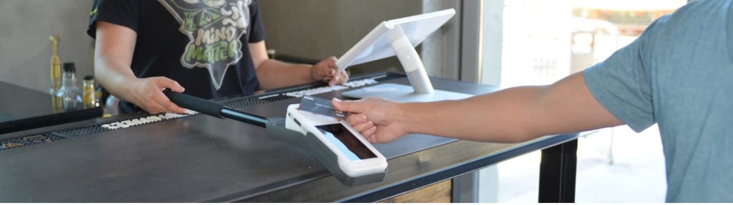 Person paying with a Clover POS system