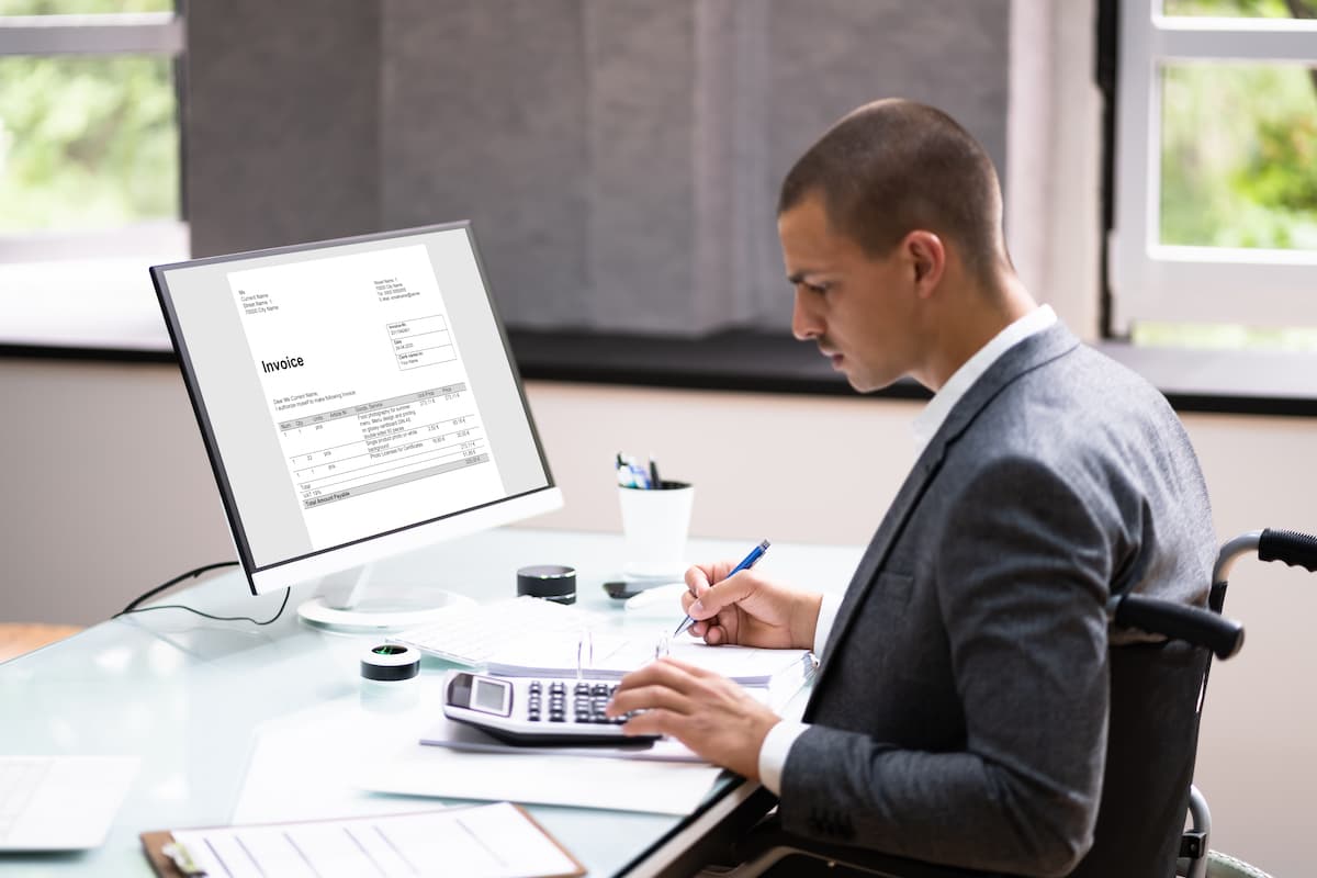person working at a desk in a wheelchair