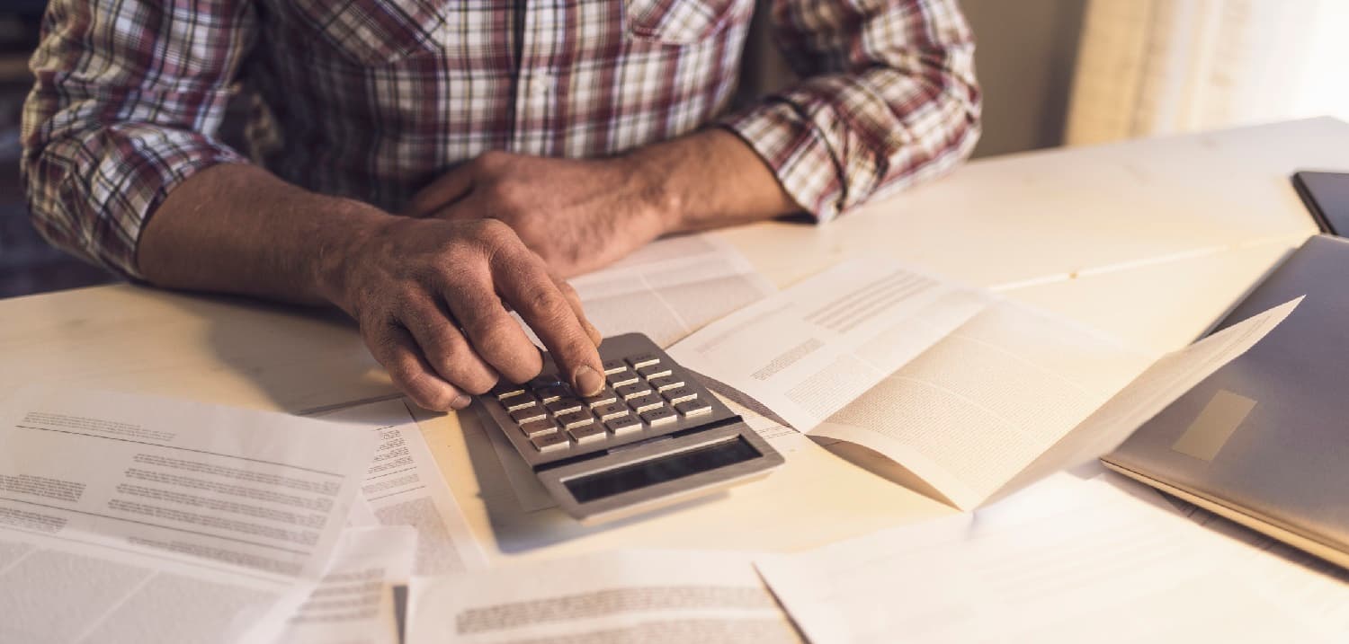 Man using a calculator for finances