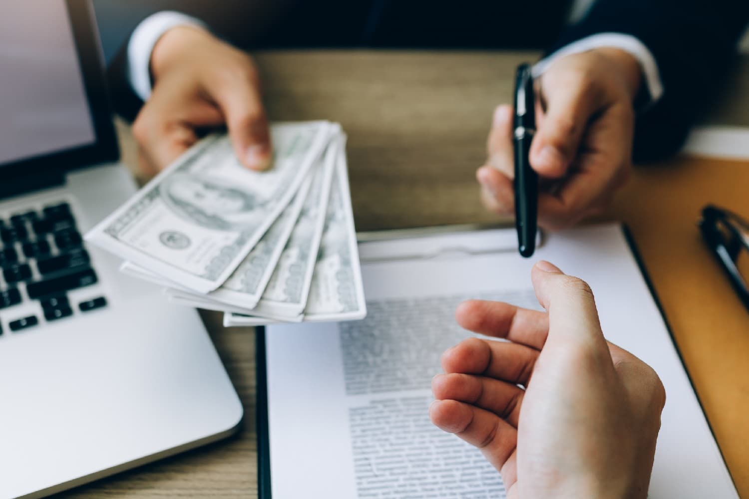 person handing someone cash