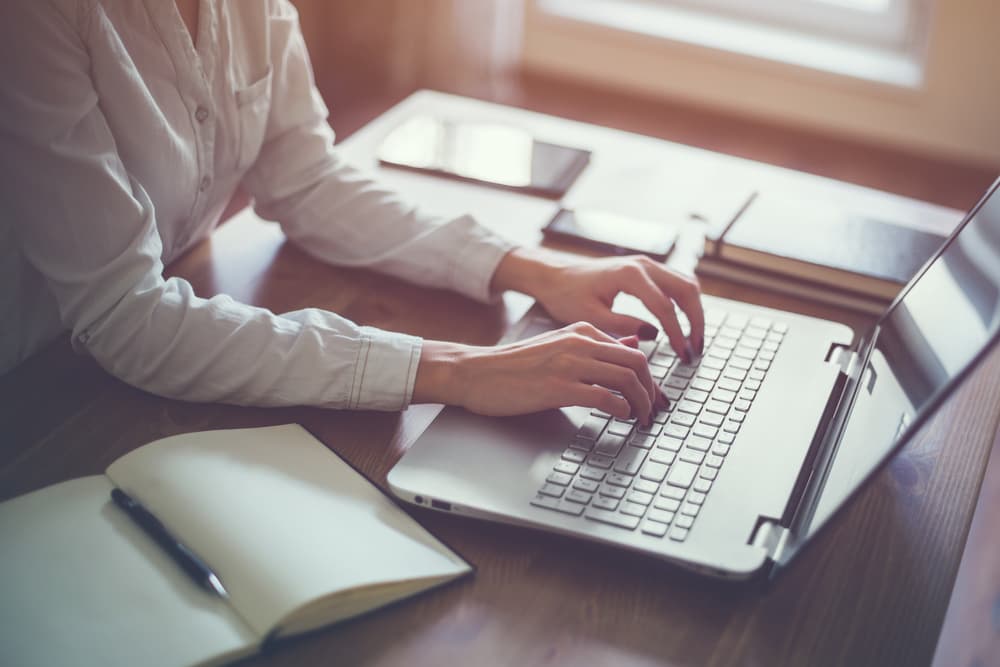 person typing on a laptop