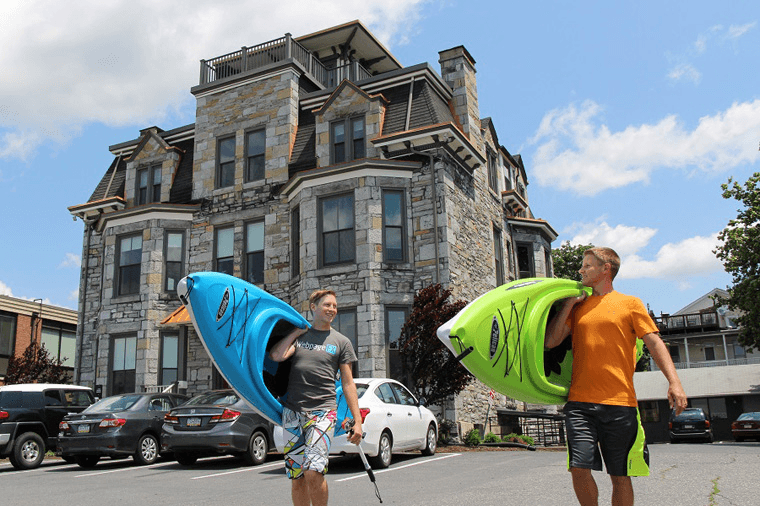 men walking with kayaks