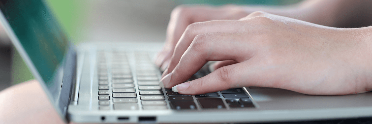 hands typing on a laptop