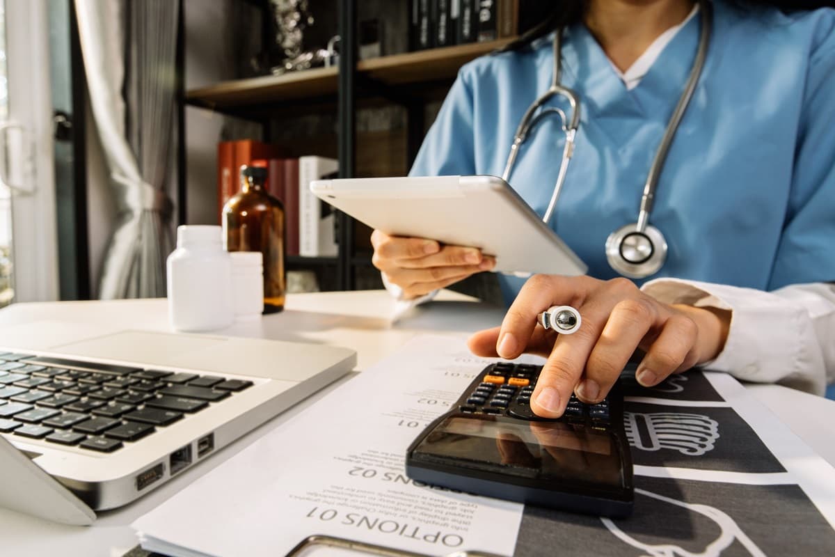 Doctor entering billing information into a computer
