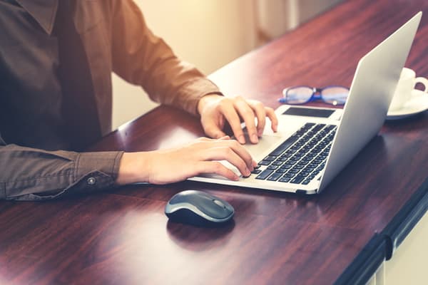 person typing on a laptop