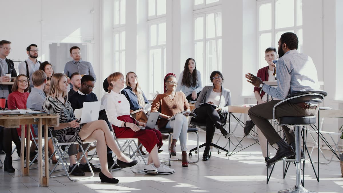 Manager talking to a room full of colleagues