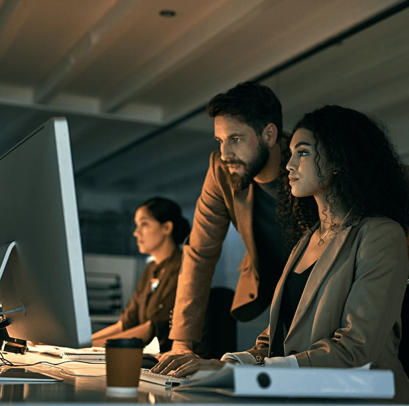 Man and woman staring at a computer