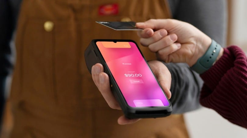 Customer making a contactless card payment with the Helcim Smart Terminal.