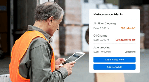 Driver using the Motive app to view maintenance alerts, including upcoming and overdue service based on mileage intervals.