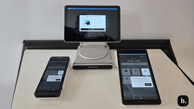 GoDaddy POS hardware setup with register terminal and mobile devices.