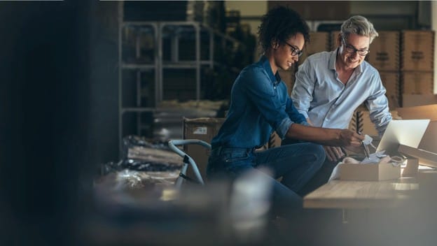 Small-business owners working on a laptop with Viasat backup internet