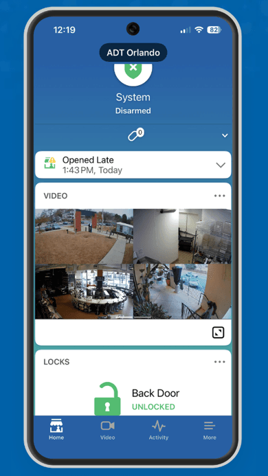 ADT Control mobile app displaying system status, live video feeds, activity alerts and remote door lock controls.