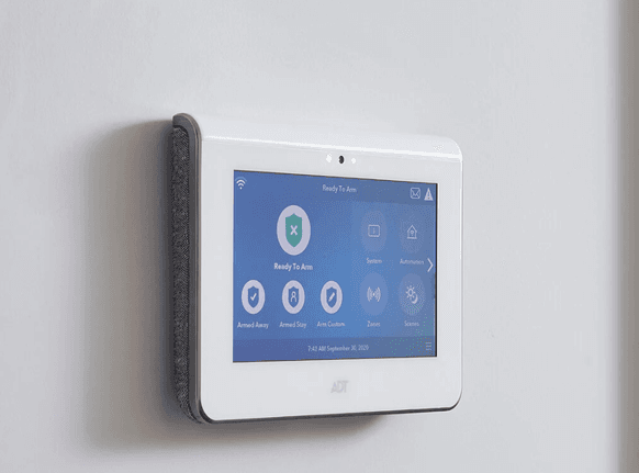 ADT touchscreen control panel displaying system status, arming options and security controls.